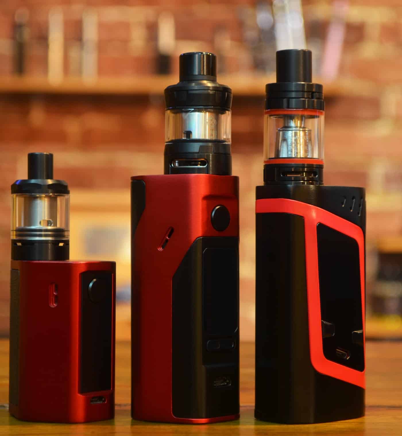 Vape mod devices with tanks, digital displays, and colorful designs for vaping enthusiasts.